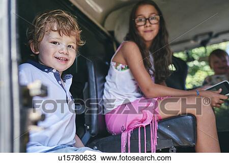 Siblings waiting in car View Large Photo Image Stock Image - Siblings waiting in car. Fotosearch