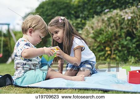 Sisters playing with blocks on picnic blanket View Large Photo Image Stock Image - Sisters playing with blocks on picnic blanket. Fotosearch