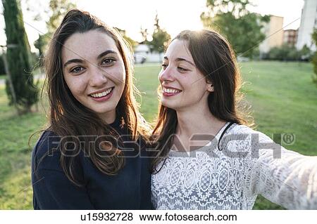 Sisters spending time together in park View Large Photo Image Stock Photo - Sisters spending time together in park. Fotosearch