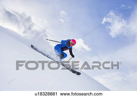 Stock Image - Skier skiing and spraying snow, Khtai, Tyrol, Austria. Fotosearch