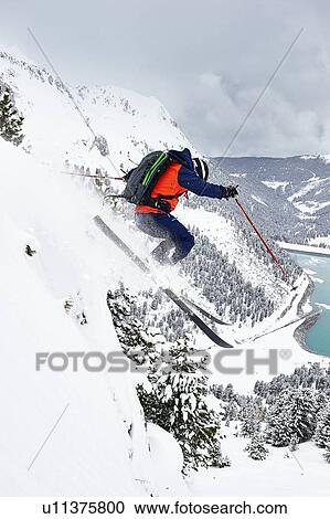Skier skiing off slope, Khtai, Austria View Large Photo Image Stock Image - Skier skiing off slope, Khtai, Austria. Fotosearch