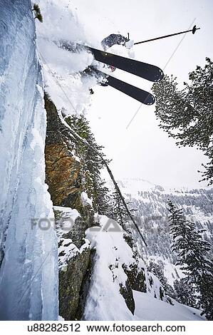 Stock Image - Skier skiing off slope, Khtai, Austria. Fotosearch