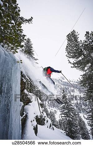 Stock Photograph - Skier skiing off slope, Khtai, Austria. Fotosearch