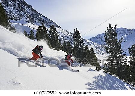Stock Image - Skiers skiing and spraying snow, Khtai, Tyrol, Austria. Fotosearch