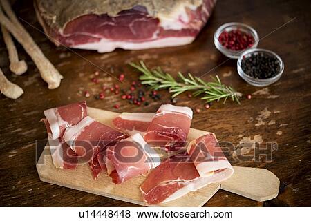 Slices of cured meat, rosemary, peppercorn View Large Photo Image Stock Photo - Slices of cured meat, rosemary, peppercorn. Fotosearch