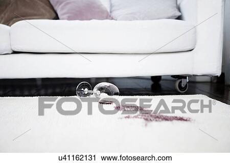 Stock Image - Spilt red wine on rug. Fotosearch