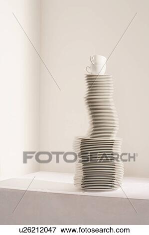 Stock Photo - Stack of plates and cups on table. Fotosearch