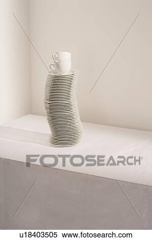 Stock Photography - Stack of plates and cups on table. Fotosearch