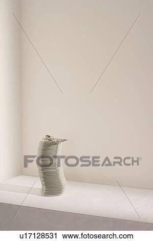 Stock Image - Stack of plates and cutlery on table. Fotosearch