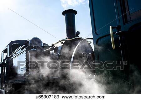 Stock Photo - Steam train emitting clouds of smoke and steam. Fotosearch