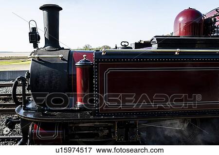 Stock Photo - Steam train passing through seaside. Fotosearch