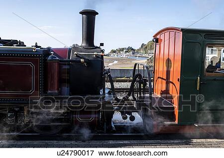 Steam train passing through seaside View Large Photo Image Stock Photo - Steam train passing through seaside. Fotosearch