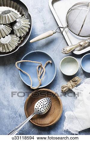 Still life of vintage kitchen utensils, bowls and cake tins. View Large Photo Image Picture - Still life of vintage kitchen utensils, bowls and cake tins.. Fotosearch