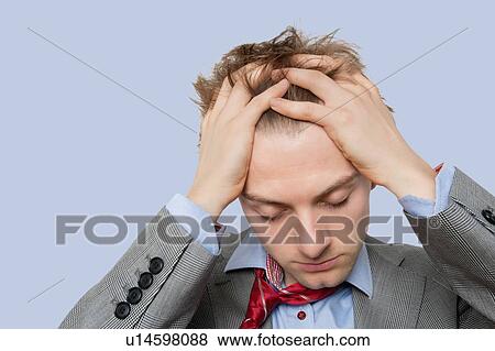 Stock Photo - Stressed businessman with hands on head. Fotosearch