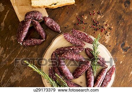 Stock Photo - Strings of sausages, rosemary, peppercorn. Fotosearch