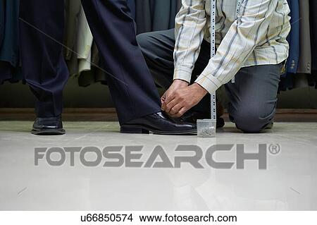 Tailor measuring business man for suit View Large Photo Image Picture - Tailor measuring business man for suit. Fotosearch