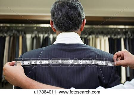 Tailor measuring business man for suit View Large Photo Image Stock Image - Tailor measuring business man for suit. Fotosearch