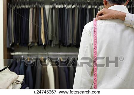 Tailor measuring business man for suit View Large Photo Image Stock Photo - Tailor measuring business man for suit. Fotosearch