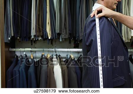 Tailor measuring business man for suit View Large Photo Image Stock Photo - Tailor measuring business man for suit. Fotosearch