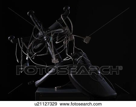 Stock Photo - Tangled computer cables and office chair. Fotosearch