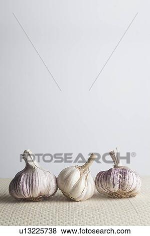 Three bulbs of garlic View Large Photo Image Stock Photo - Three bulbs of garlic. Fotosearch