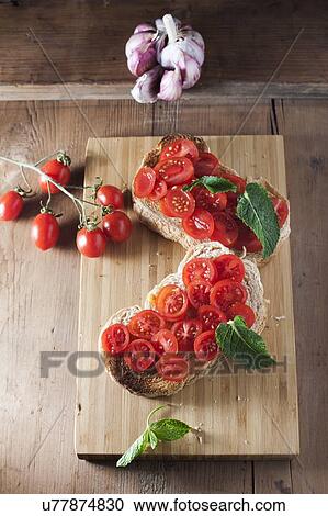 Toasted bread with tomatoes, garlic and herbs View Large Photo Image Stock Image - Toasted bread with tomatoes, garlic and herbs. Fotosearch