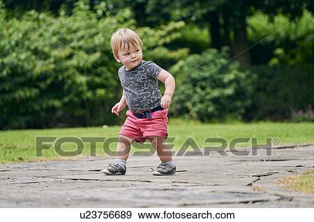 Stock Photo - Toddler exploring park. Fotosearch