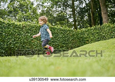 Stock Photo - Toddler exploring park. Fotosearch