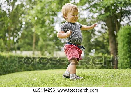 Stock Photograph - Toddler exploring park. Fotosearch
