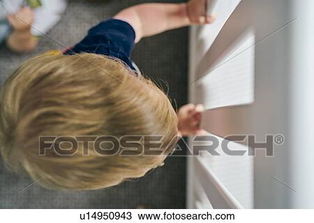 Toddler peeking through glass door View Large Photo Image Stock Image - Toddler peeking through glass door. Fotosearch