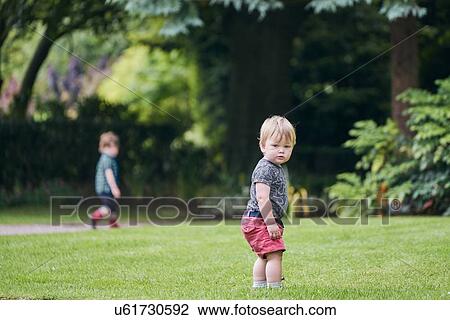 Stock Image - Toddlers exploring park. Fotosearch