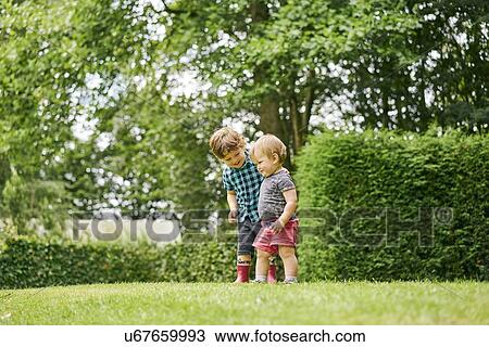 Stock Image - Toddlers exploring park. Fotosearch