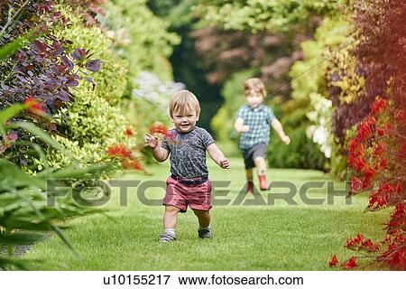 Toddlers exploring park View Large Photo Image Stock Photo - Toddlers exploring park. Fotosearch