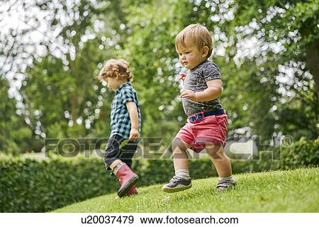 Stock Photo - Toddlers exploring park. Fotosearch