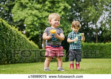Toddlers exploring park View Large Photo Image Stock Photography - Toddlers exploring park. Fotosearch