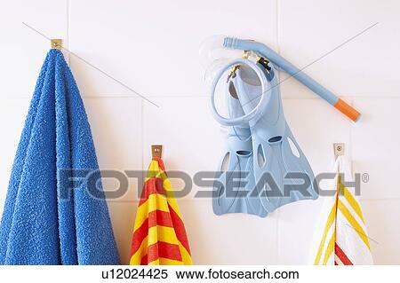 Towels, snorkel tube and flippers hanging on bathroom wall View Large Photo Image Stock Photography - Towels, snorkel tube and flippers hanging on bathroom wall. Fotosearch