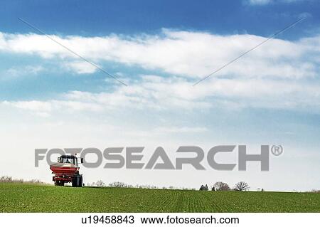 Tractor fertilizing wheat crop field with NPK View Large Photo Image Stock Image - Tractor fertilizing wheat crop field with NPK. Fotosearch