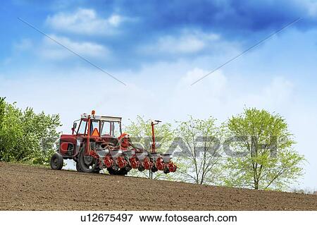 Stock Photo - Tractor with mounted crop seeder. Fotosearch
