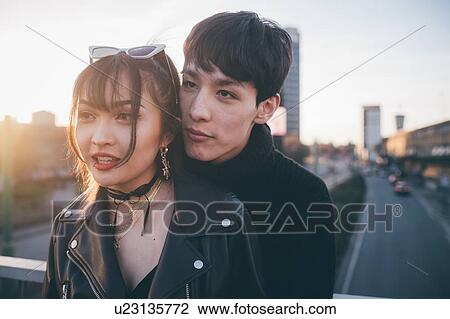 Trendy couple hugging on bridge, Milan, Italy View Large Photo Image Stock Image - Trendy couple hugging on bridge, Milan, Italy. Fotosearch