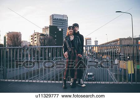 Trendy couple hugging on bridge, Milan, Italy View Large Photo Image Stock Photo - Trendy couple hugging on bridge, Milan, Italy. Fotosearch
