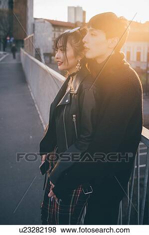 Trendy couple hugging on bridge, Milan, Italy View Large Photo Image Stock Photo - Trendy couple hugging on bridge, Milan, Italy. Fotosearch