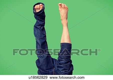 Stock Photo - Trying to put on trousers upside down. Fotosearch