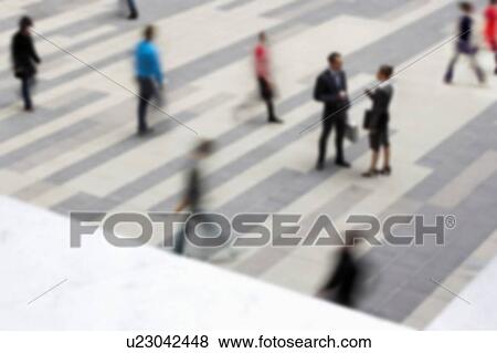 Stock Photo - Two business people talking in blurred crowd. Fotosearch