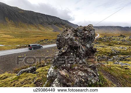 Stock Photo - Vehicle driving on road along volcanic lava field, Snaefellsbaer, Vesturland, Iceland. Fotosearch