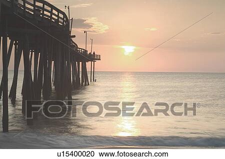View of sunset over sea with pier View Large Photo Image Stock Image - View of sunset over sea with pier. Fotosearch