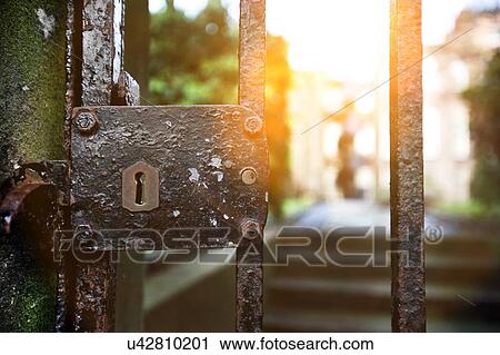 Vintage lock on iron gate with sunshine View Large Photo Image Stock Image - Vintage lock on iron gate with sunshine. Fotosearch