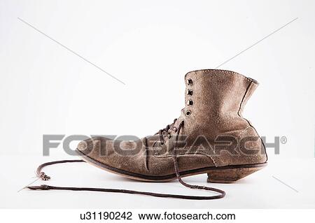 Stock Image - Vintage Well worn brown boots. Fotosearch