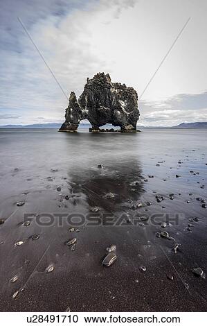 Stock Image - Volcanic rock formation in the shallows on a black sand beach, Hvitserkur, Nordurland Vestra, Iceland. Fotosearch