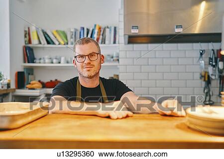 Waiter waiting at service counter in restaurant View Large Photo Image Stock Image - Waiter waiting at service counter in restaurant. Fotosearch