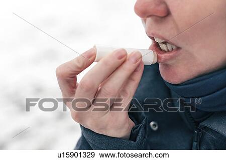 Woman applying lip balm View Large Photo Image Stock Photo - Woman applying lip balm. Fotosearch